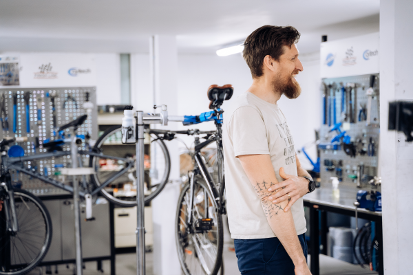 Man Standing In Bike Workshop Resized 600w