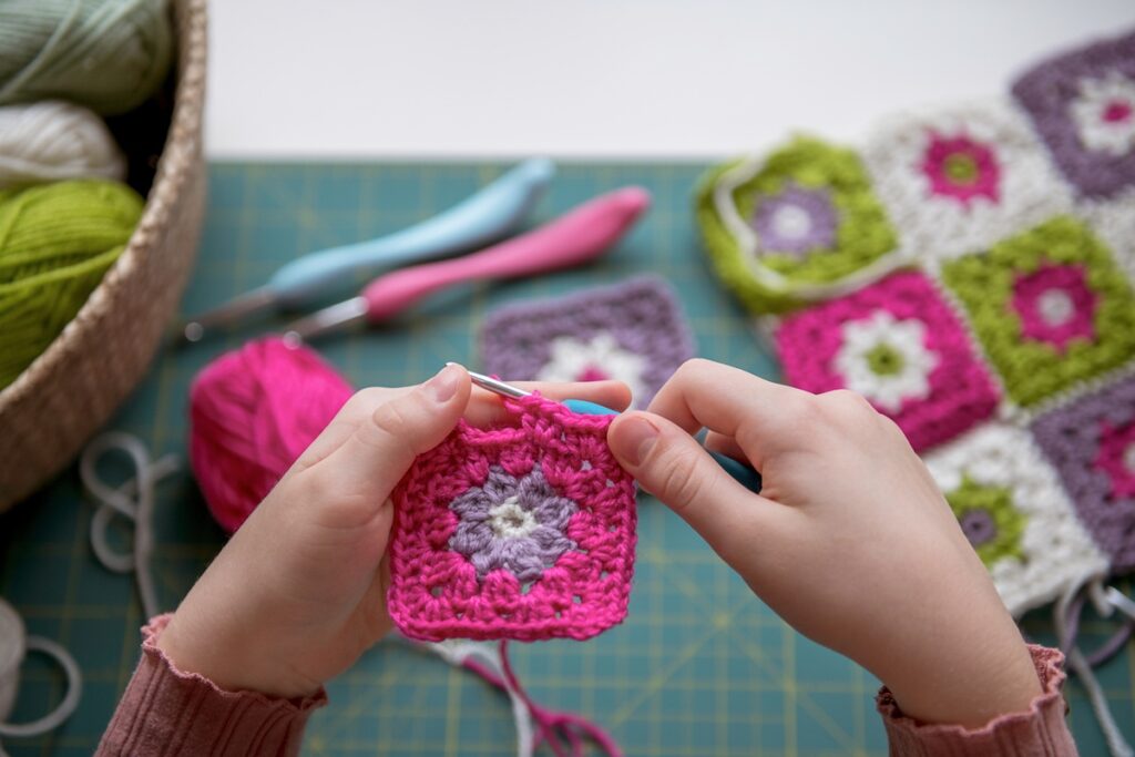 Child Doing Colorful Crochet Craft Project At Home